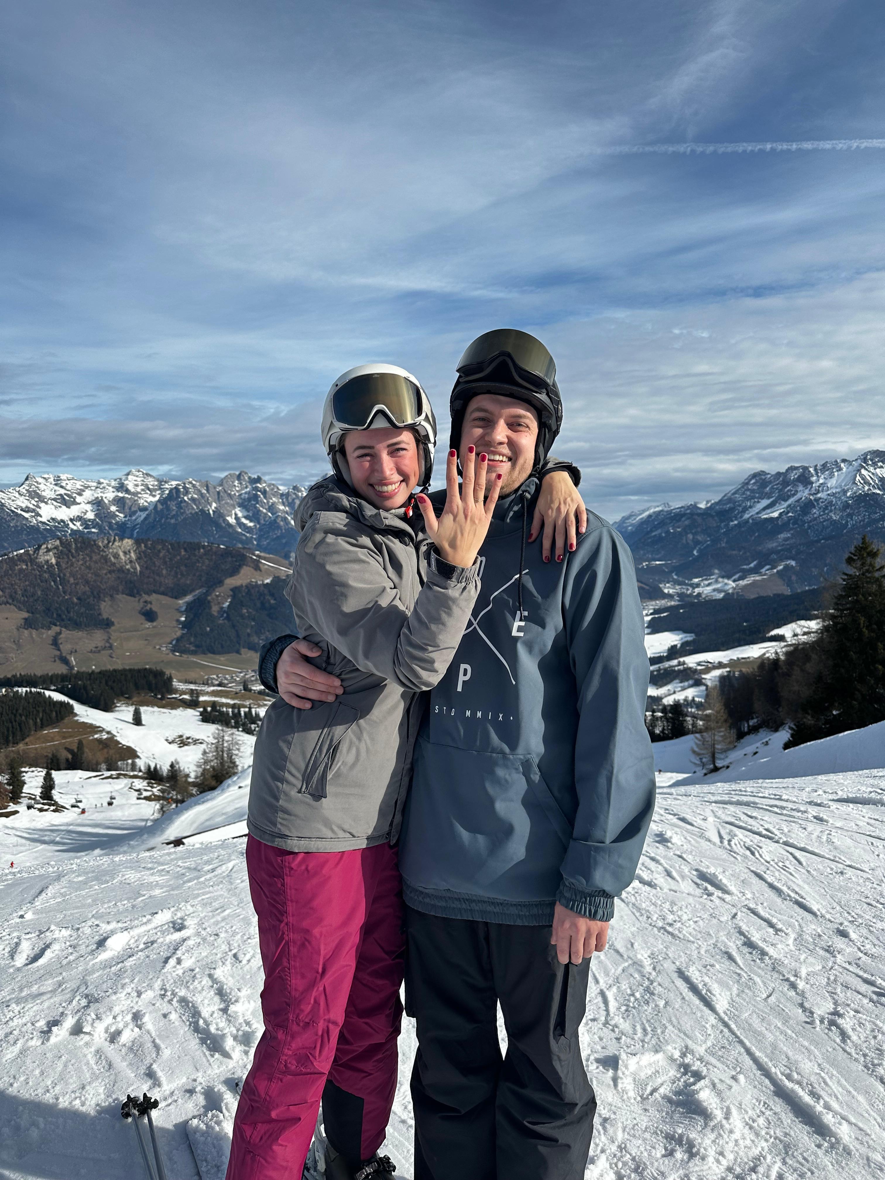 3 flowers placed in a vintage glass jar with a soft green background.