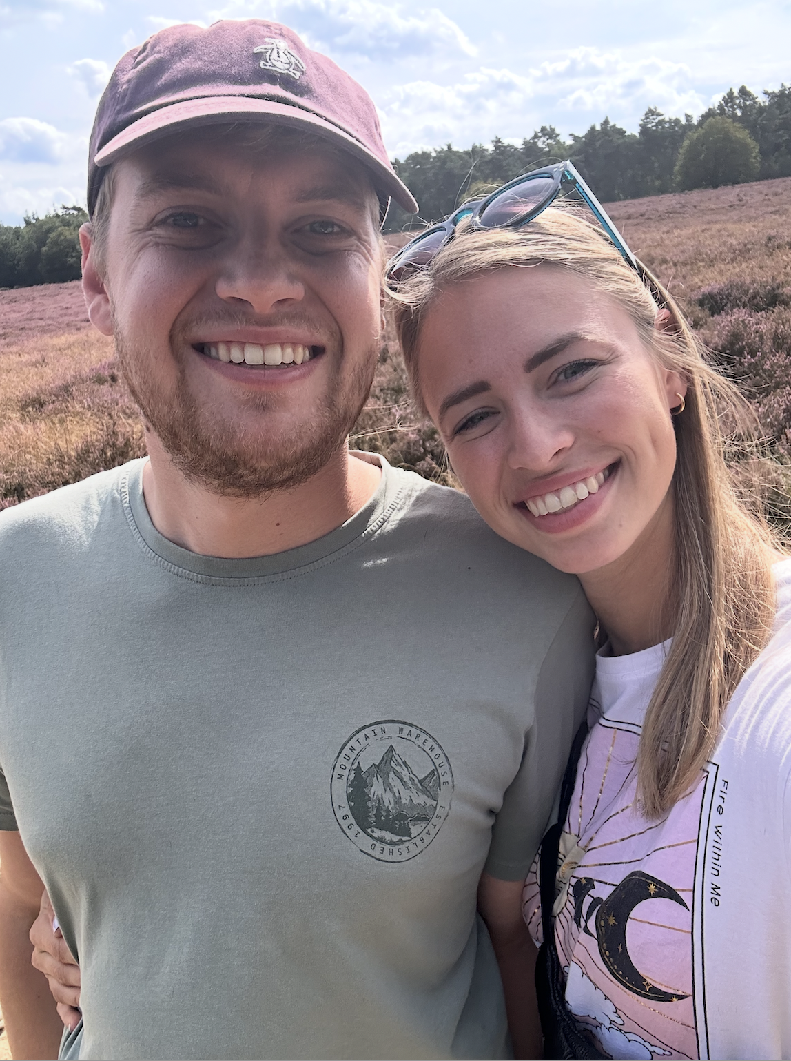 Polaroid photo of a couple posing together on a bed with the date 06/10/19 written on the polaroid.